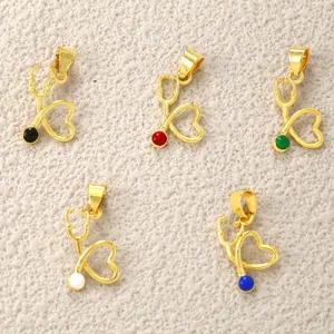 Gold stethoscope heart pendant detail view, colorful enamel charms for DIY jewelry making.