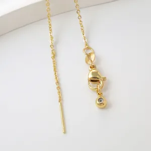 Gold DIY jewelry finding chain detail close-up, lobster clasp with delicate pin and metal link design.