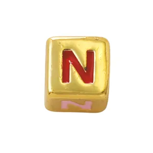 Gold square letter bead detail, red enamel alphabet design for custom DIY jewelry making.