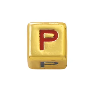 Detail shot of a gold square alphabet bead with red enamel letter P for DIY jewelry.