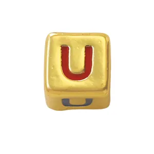 Gold square letter bead detail, red enamel inlay U character, DIY jewelry component close up