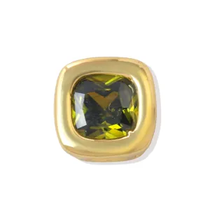 Detailed close up of square green zircon charm, thick brass gold tone DIY jewelry bead.