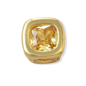 Close-up detail of a square bezel-set yellow zircon brass DIY charm bead accessory.