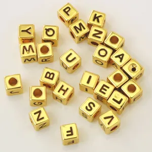 Gold square alphabet letter beads for DIY bracelet and necklace jewelry making projects.