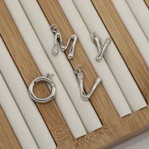 Silver tone letter metal charms with small stones, perfect for DIY jewelry necklaces.