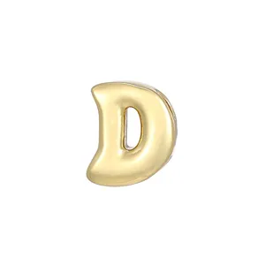 Close-up van gouden opgeblazen letter D hanger, ballonstijl alfabet bedel voor DIY sieraden.