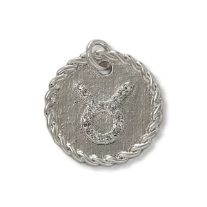 Detailed shot of a silver tone Taurus zodiac pendant, micro-paved with sparkling cubic zirconia.