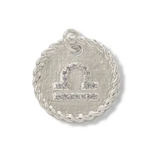 Libra zodiac pendant detail shot, sparkling cubic zirconia micro pave, silver tone medal charm.