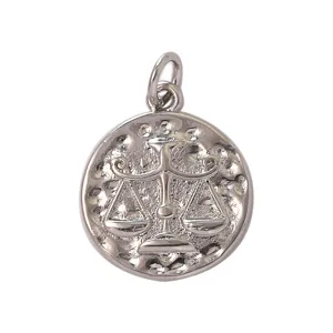 Detailed view of vintage silver Libra zodiac sign metal charm pendant with textured hammer design.