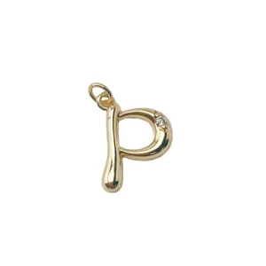 Close-up detail of gold plated letter P pendant with sparkling crystal for DIY jewelry making.