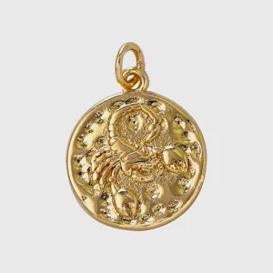 Detailed shot of a gold-plated vintage Scorpio zodiac coin pendant charm for DIY jewelry making.