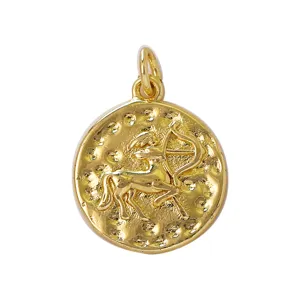 Gold Sagittarius zodiac pendant detail showing textured coin surface and jump ring bail.
