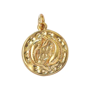 Close-up detail of the vintage gold plated zodiac pisces pendant jewelry making accessory.