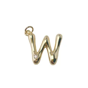 Detailed close-up of gold-plated letter W pendant with sparkling crystal stone accent.