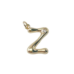 Detailed close-up of gold-plated letter Z pendant with sparkling crystal stone accent.