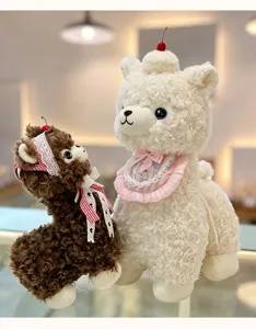 Close-up detail of adorable fluffy alpaca plush toys featuring sweet dessert hats.