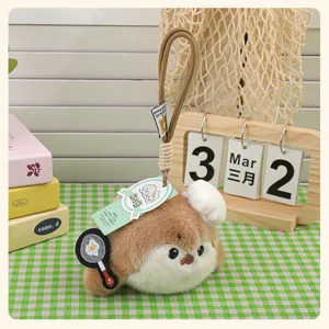 Cute plush sea otter bag charm with chef hat and frying pan design, soft stuffed plushie.
