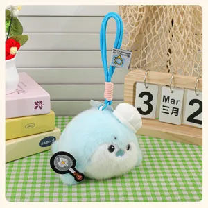 Cute blue plush seal otter keychain detail, chef hat frying pan design, soft fluffy toy pendant.