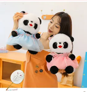 Detail view of cute Chinese Hanfu giant panda plush toy doll with traditional dress and fan.