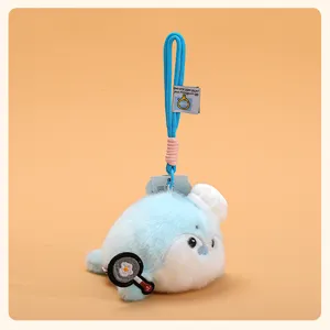 Cute blue otter plush pendant with chef hat and frying pan, soft toy keychain for bags.
