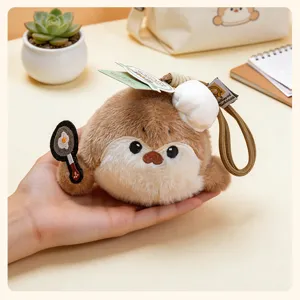 Cute plush pendant detail shot, soft brown otter holding a frying pan, perfect bag charm gift.