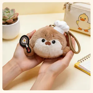 Cute plush sea otter keychain with chef hat and fried egg accessory, soft bag pendant for gifts.