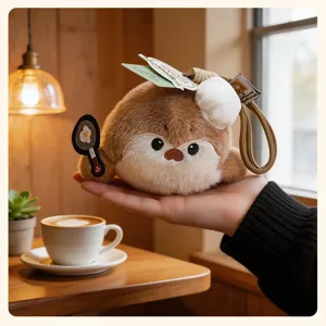 Cute plush sea otter keychain with chef hat and frying pan, soft bag pendant accessory for women.