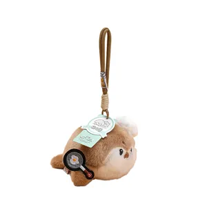 Cute plush sea otter keychain with chef hat and fried egg pendant for bags and gifts.