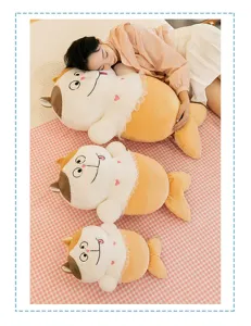 Cute cat mermaid plush toy detail, soft long pillow display on cozy bed for warm home decor.