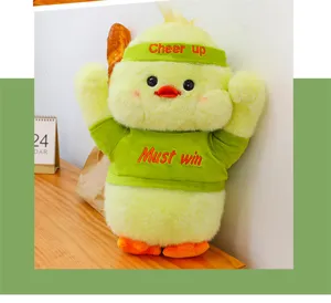Cute yellow duck plush toy with green cheer up outfit and headband, soft stuffed doll gift.