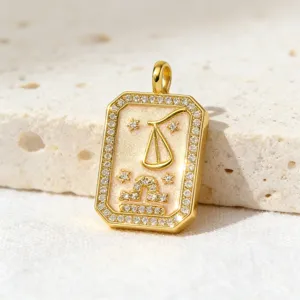 Close-up detail of a gold-plated tarot zodiac pendant paved with sparkling clear cubic zirconia.