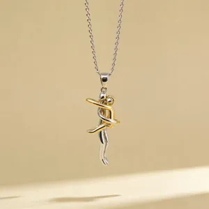 Two-tone hugging couple pendant necklace detail view, minimalist design silver and gold finish.