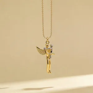 Close-up of the delicate two-tone embracing figures pendant necklace, elegant everyday jewelry.