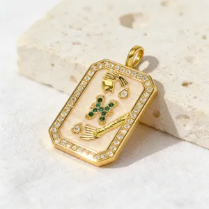 Pisces zodiac pendant detail shot, gold-plated copper paved with white and green zirconia stones.