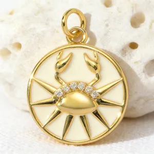 Detailed shot of a gold-plated round Cancer zodiac pendant with white enamel and zirconia.