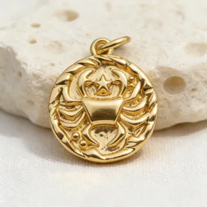 Detailed view of vintage gold-plated zodiac cancer coin pendant, exquisite relief jewelry accessory.