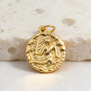 Gold coin pendant detail showing intricate antique relief figure and textured rim.
