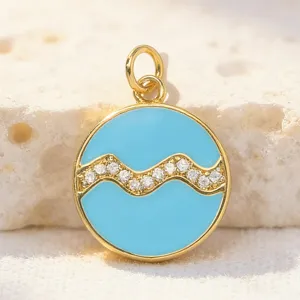Detailed close-up view of a round blue enamel zodiac pendant with cubic zirconia inlay.