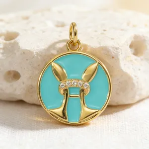 Gold plated turquoise enamel round zodiac pendant with sparkling cubic zirconia stones.