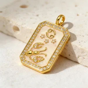 Detailed view of the gold-plated Cancer zodiac pendant, featuring sparkling cubic zirconia stones.