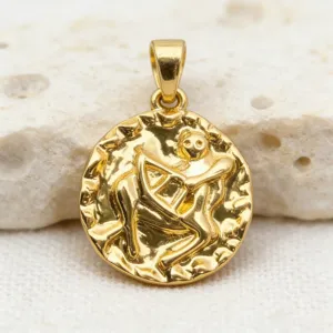 Close-up shot of vintage gold coin pendant featuring detailed zodiac relief design.