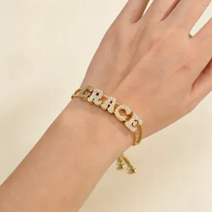 Close-up detail of custom letter bracelet featuring micro-paved cubic zirconia charms.