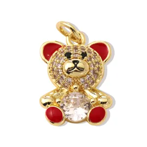 Cute teddy bear gold pendant necklace with shiny cubic zirconia and red enamel details.
