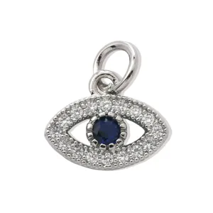 Close-up detail shot of silver evil eye pendant with sparkling clear zirconia and dark blue stone.
