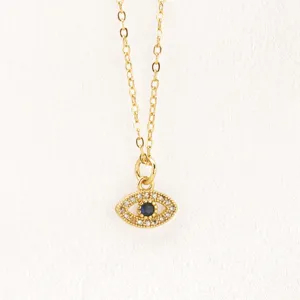 Gold evil eye pendant necklace with blue center stone and crystal pavé details for women.