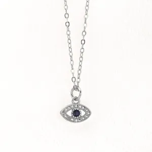 Evil eye pendant necklace detail view, exquisite pavé crystal silver tone chain aesthetic design.
