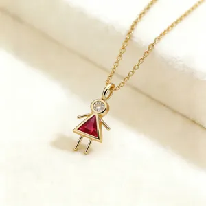 Collar con colgante de niña dorada con circonita brillante y piedra de color rojo.