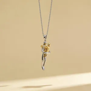 Two-tone hugging couple pendant necklace, minimalist silver and gold clavicle chain detail.