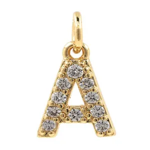 Detailed view of a gold plated letter A pendant paved with sparkling cubic zirconia stones.