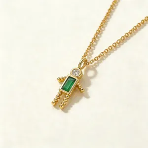 Collar con colgante de niño de cobre chapado en oro con circonitas verdes y blancas.